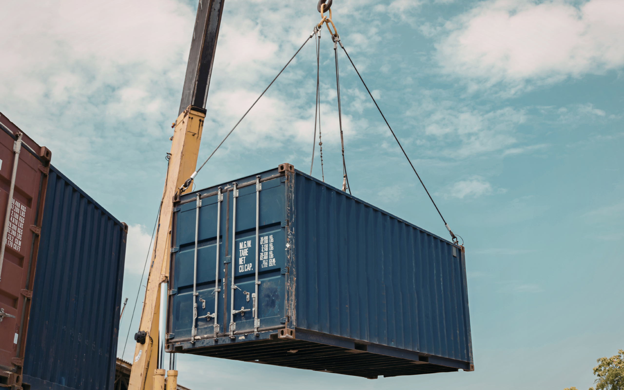 Shipping container being lifted 