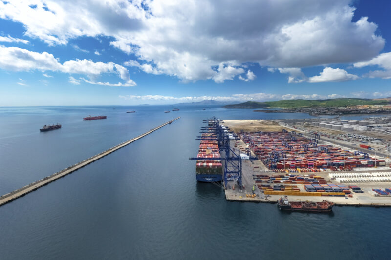Aerial view of the TTI Algeciras container terminal in Spain, with ship-to-shore cranes working a large container vessel at the quay